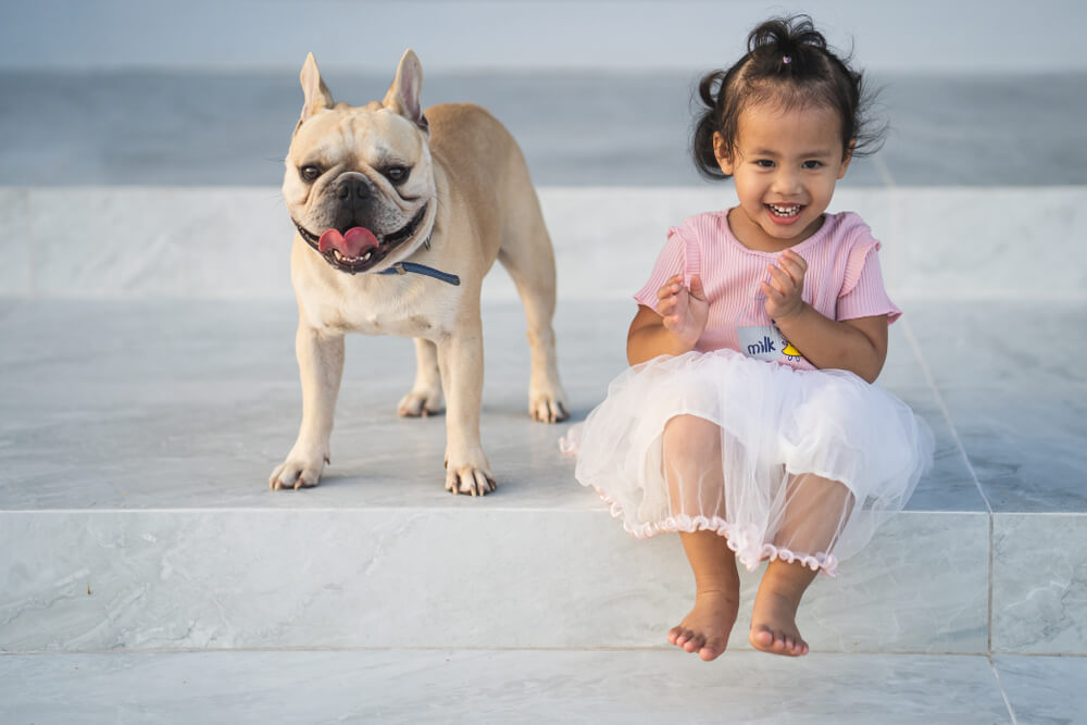 little-girl-smiles-with-her-pet-bull-dog