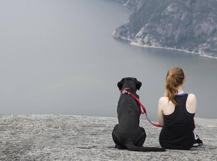 young-woman-takes-her-black-lab-on-a-long-hike