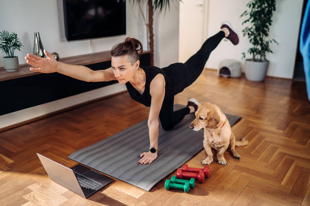 woman-exercises-at-home-with-her-dog