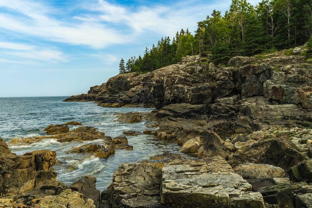 Treelined-natural-rock-beach-at-Acadia-National-Park