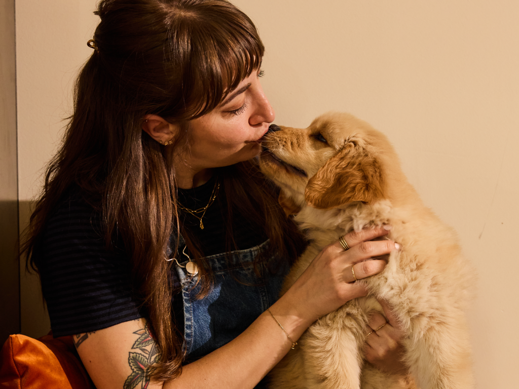 Human kissing a puppy.