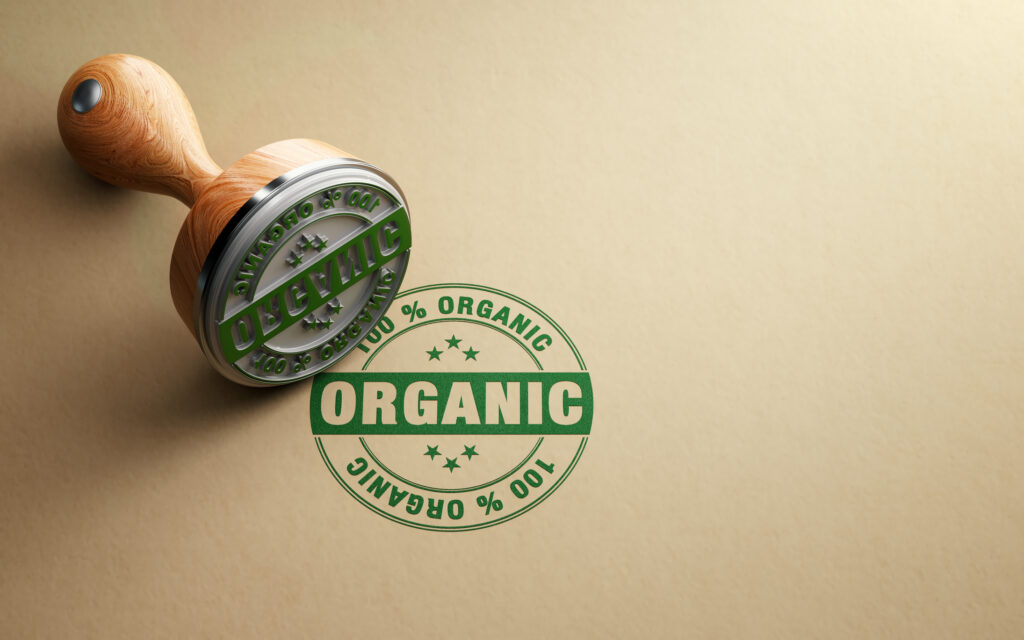 Wooden 100 % organic stamp on recycled paper. Horizontal composition with copy space. High angle view.